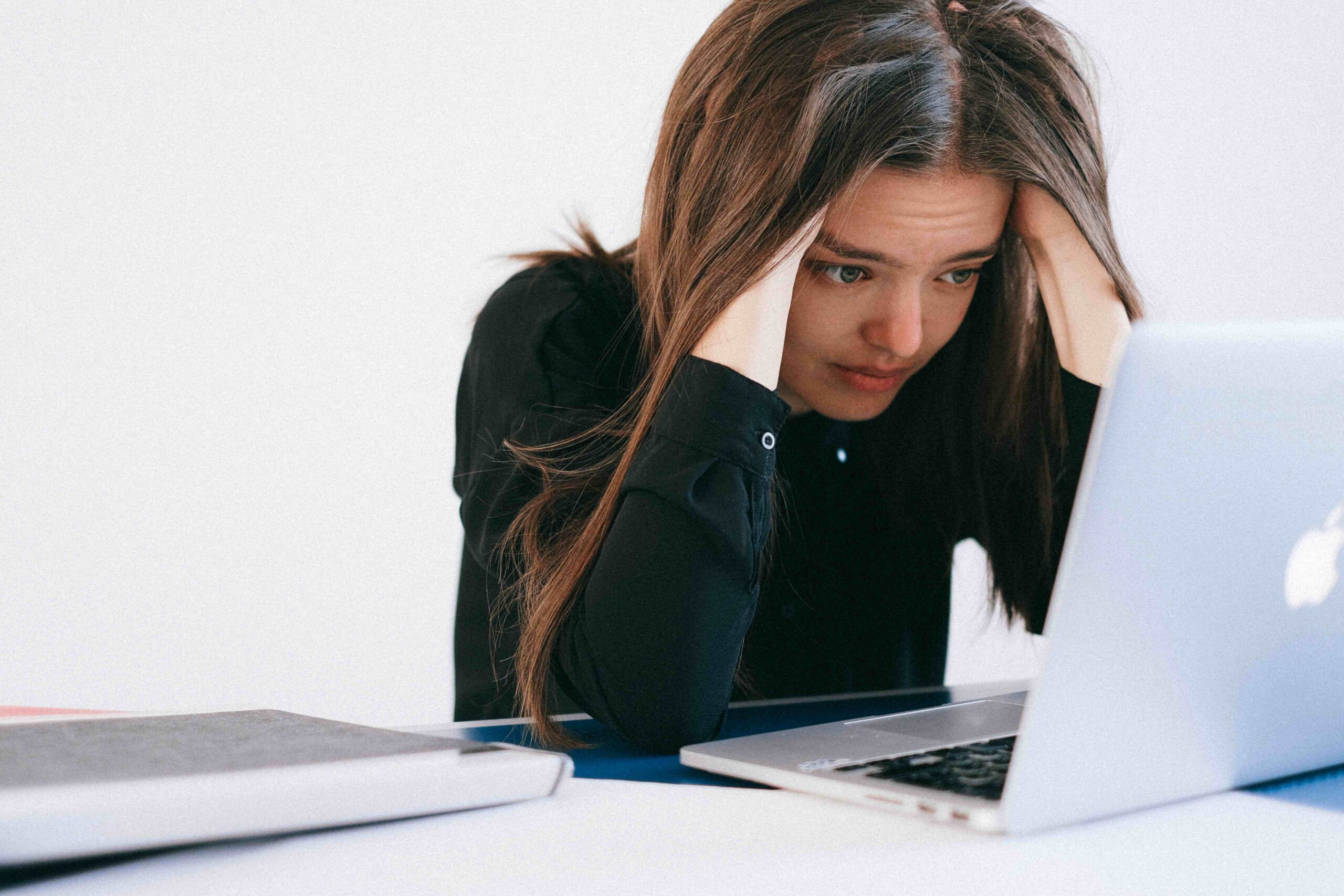 sad woman working on laptop
